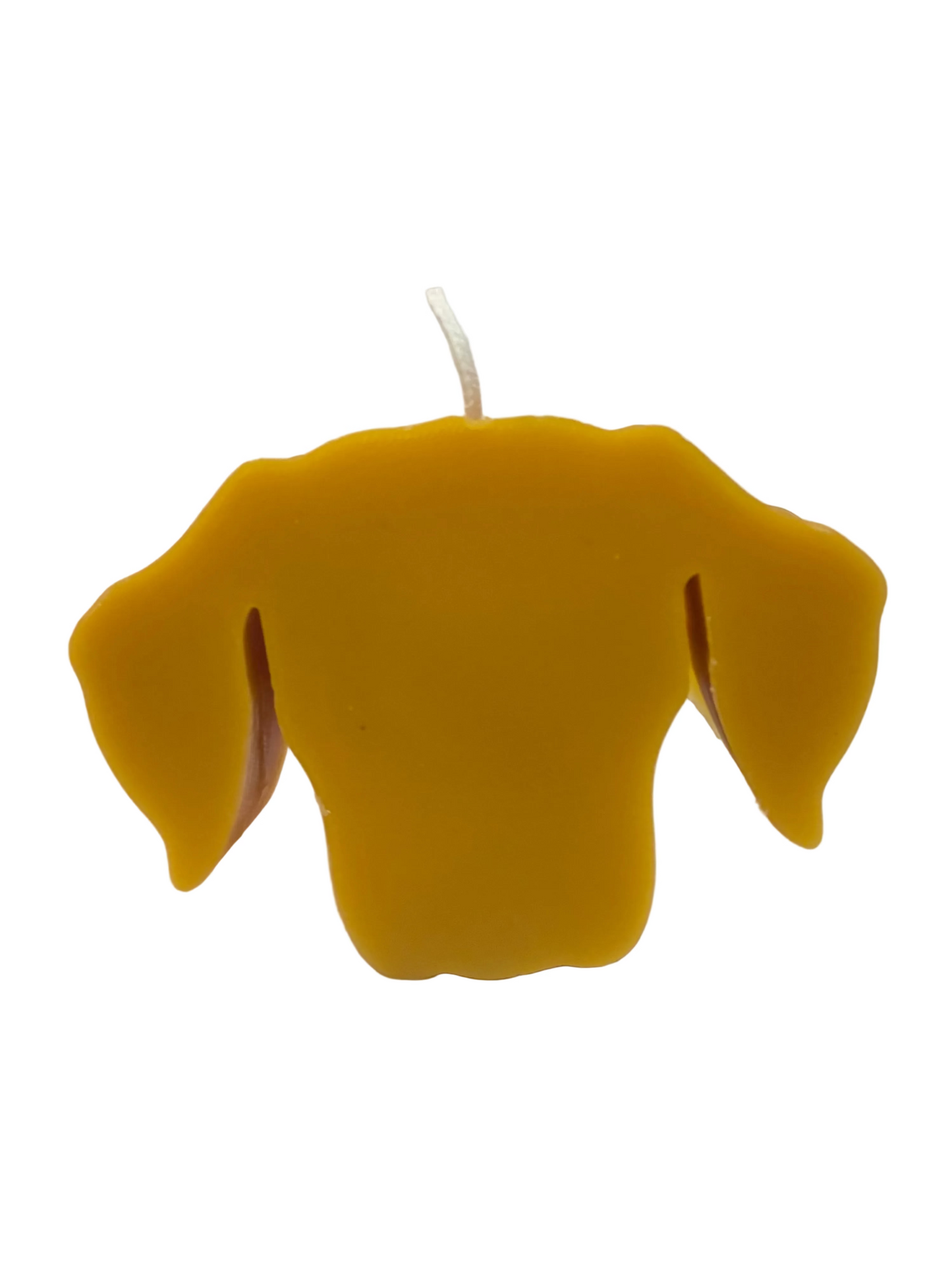 Yellow dog-shaped candle on a white background