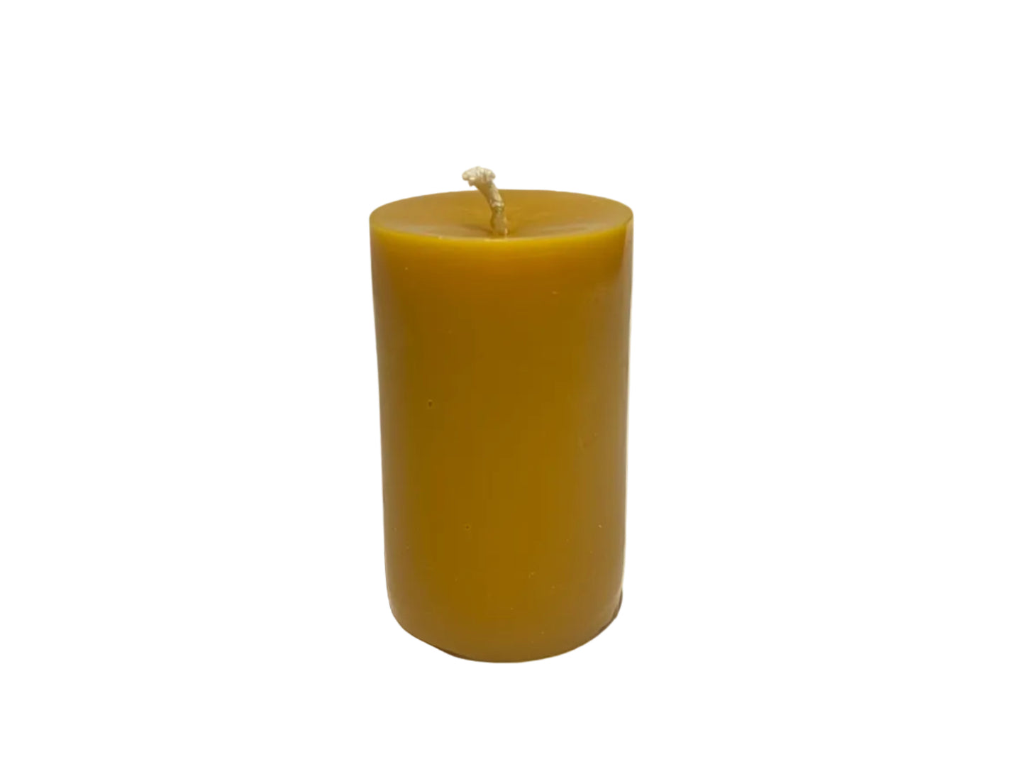 Yellow beeswax pillar candle on a white background
