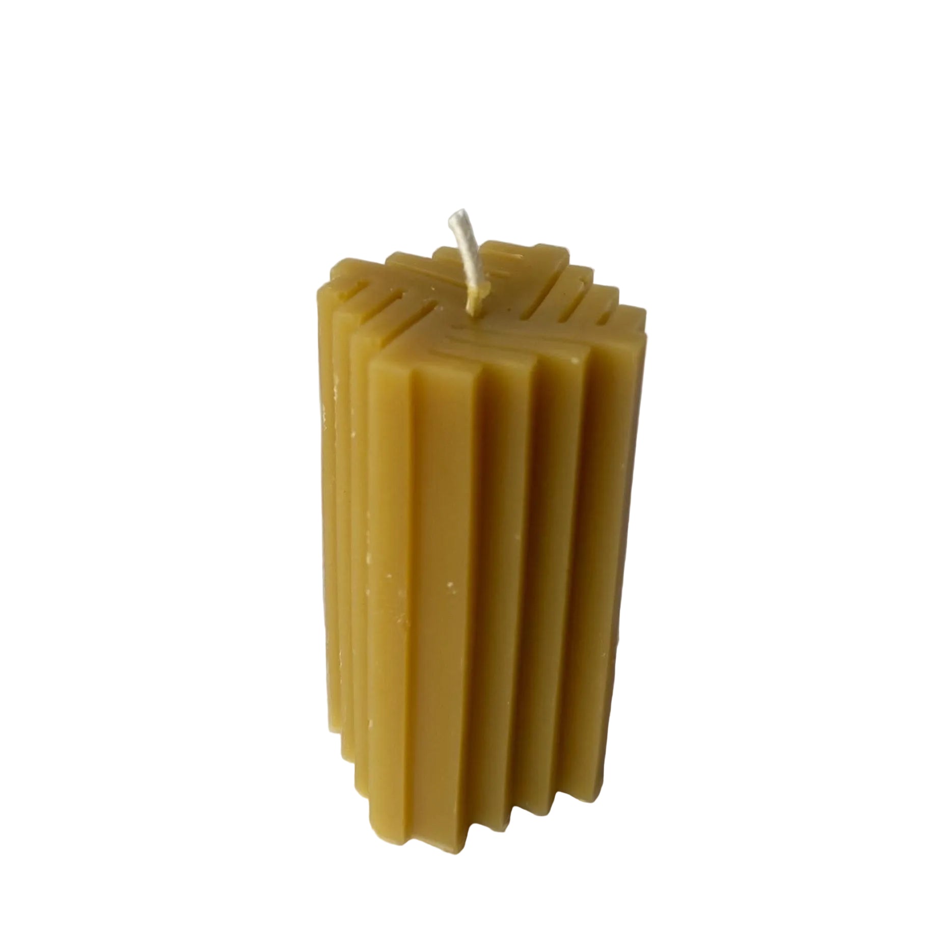 Beeswax candle with a textured pattern on a white background