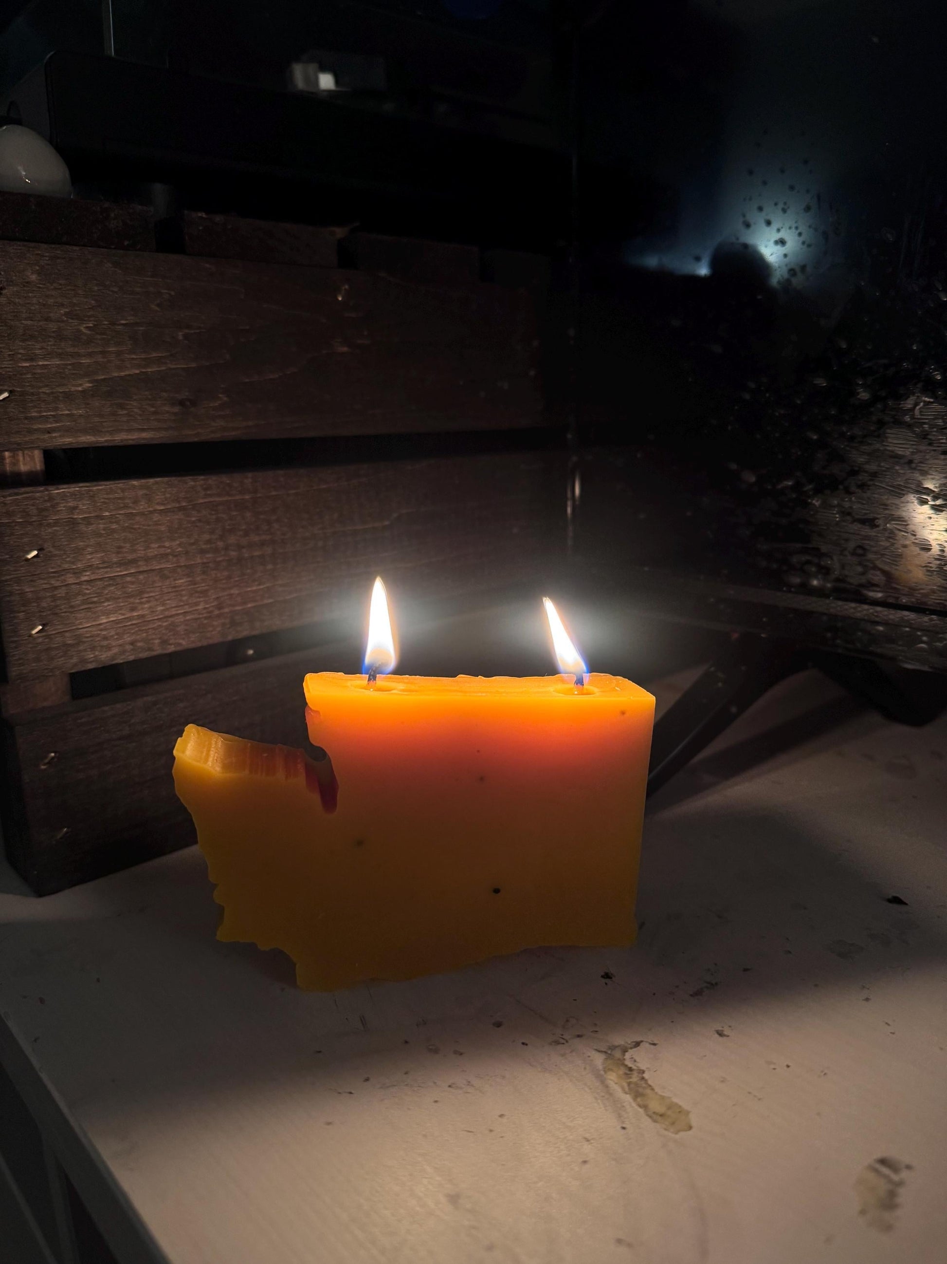 Lit beeswax candle with cotton wick