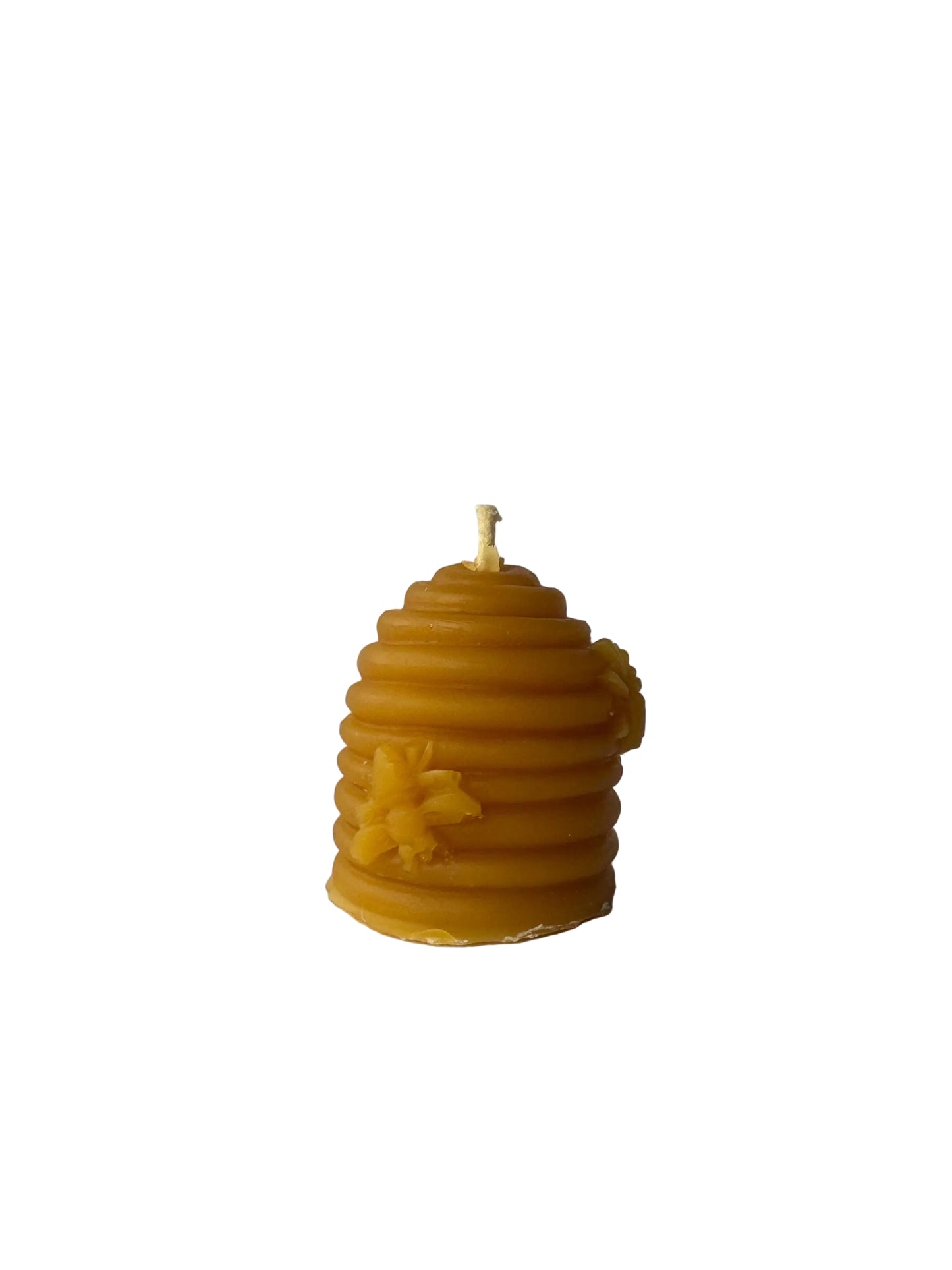 Beeswax candle shaped like a beehive on a white background