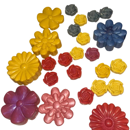 Colorful flower-shaped Crayons on a beige surface