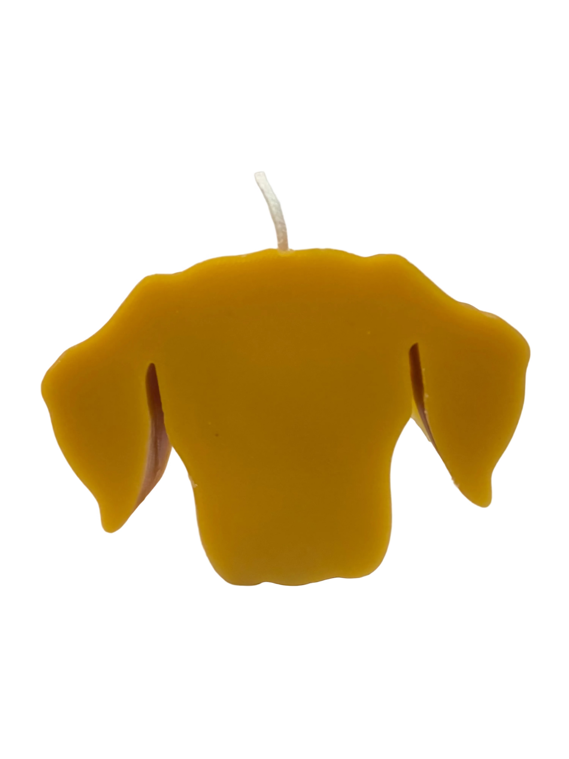 Yellow dog-shaped candle on a white background