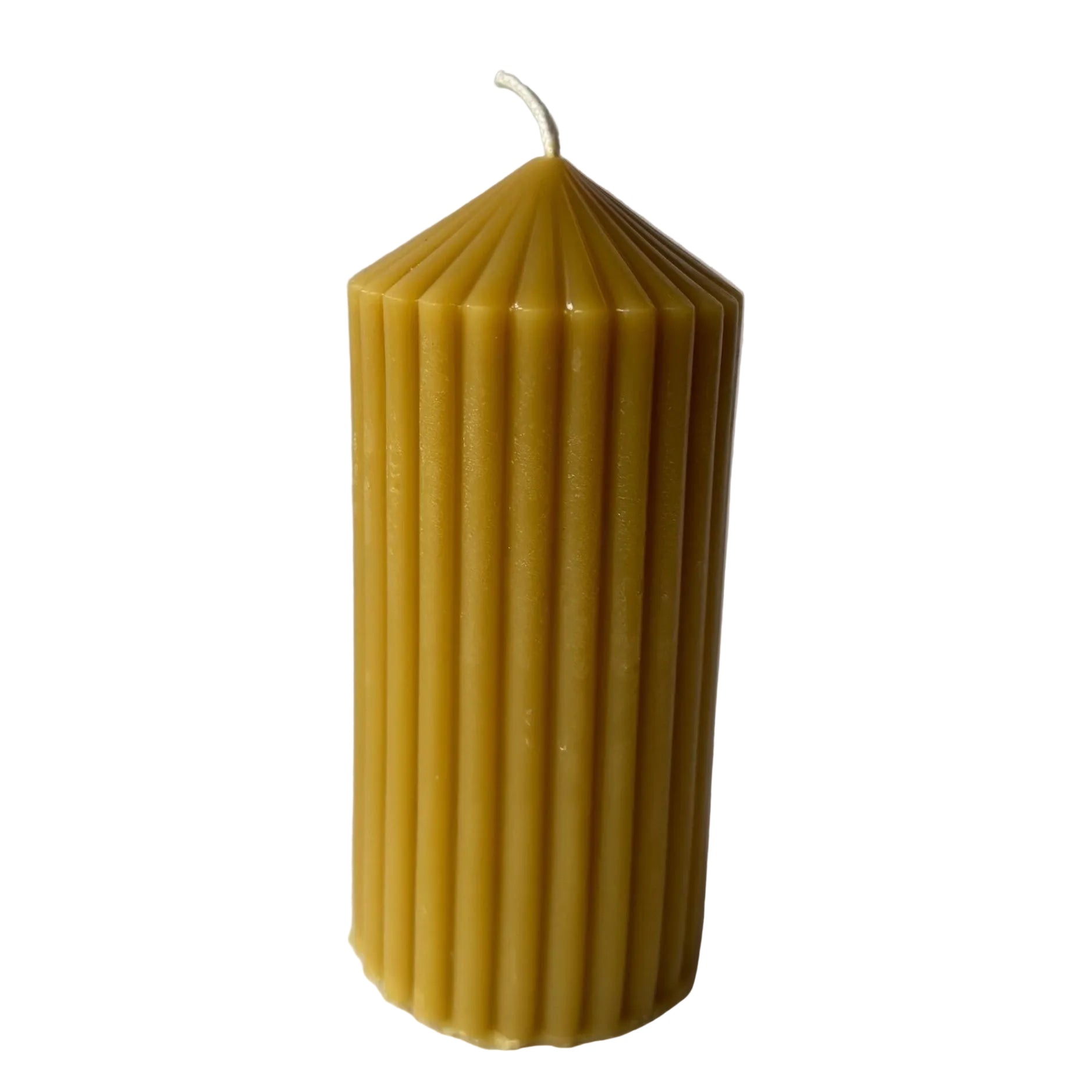 Beeswax pillar  candle with a ribbed texture on a white background