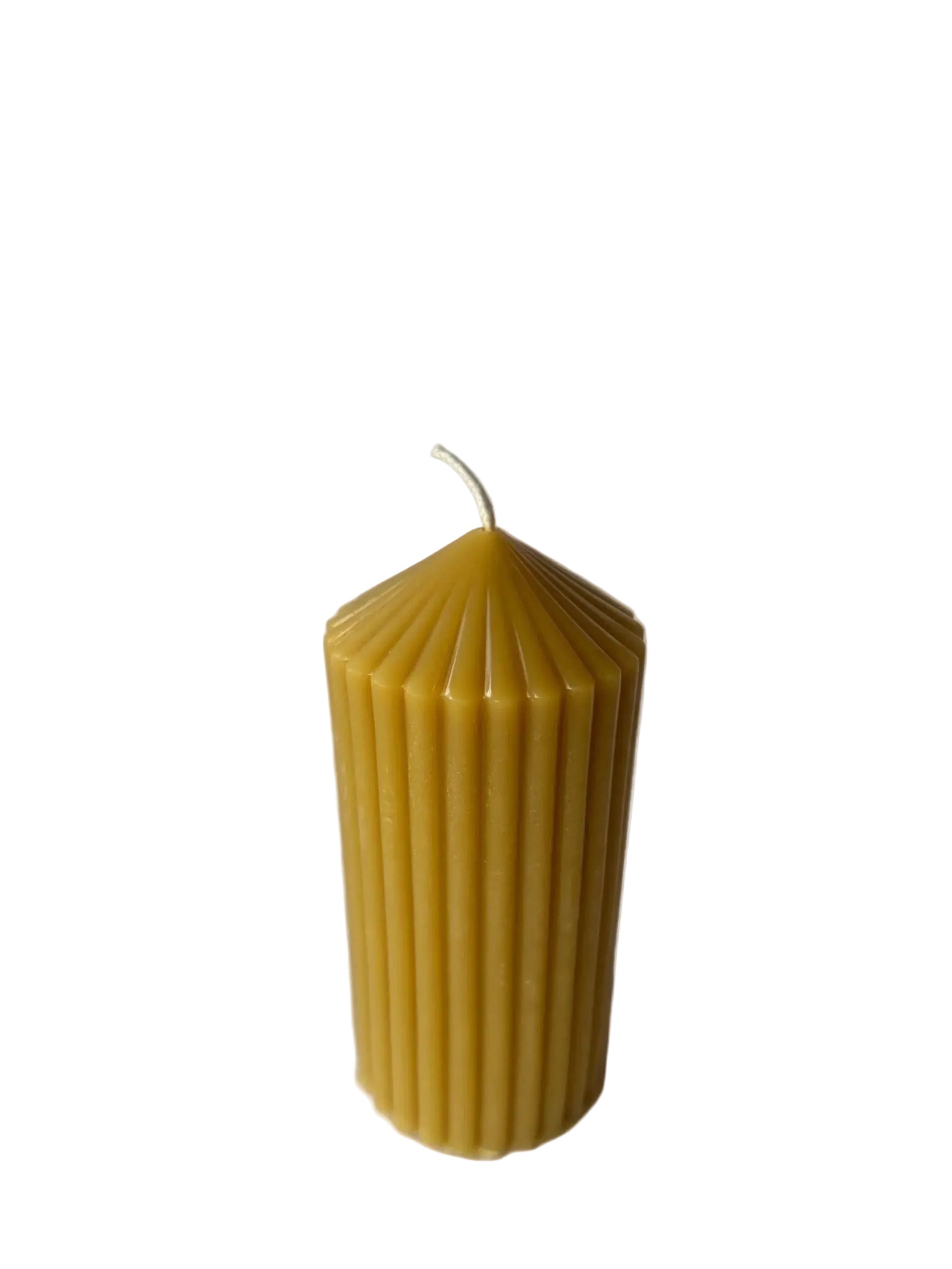 Beeswax candle with ribbed texture on a plain background