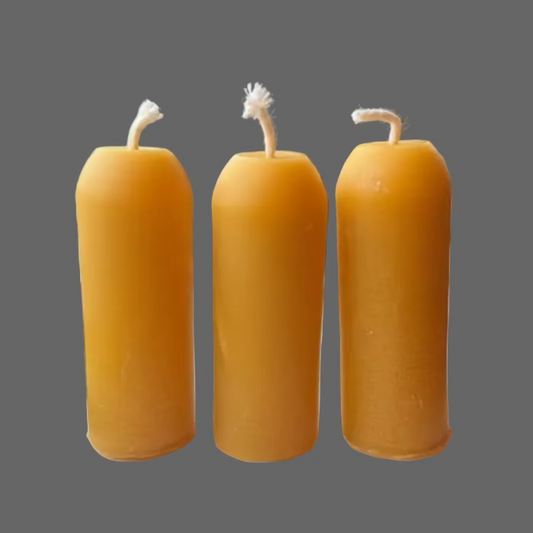 three yellow beeswax candles