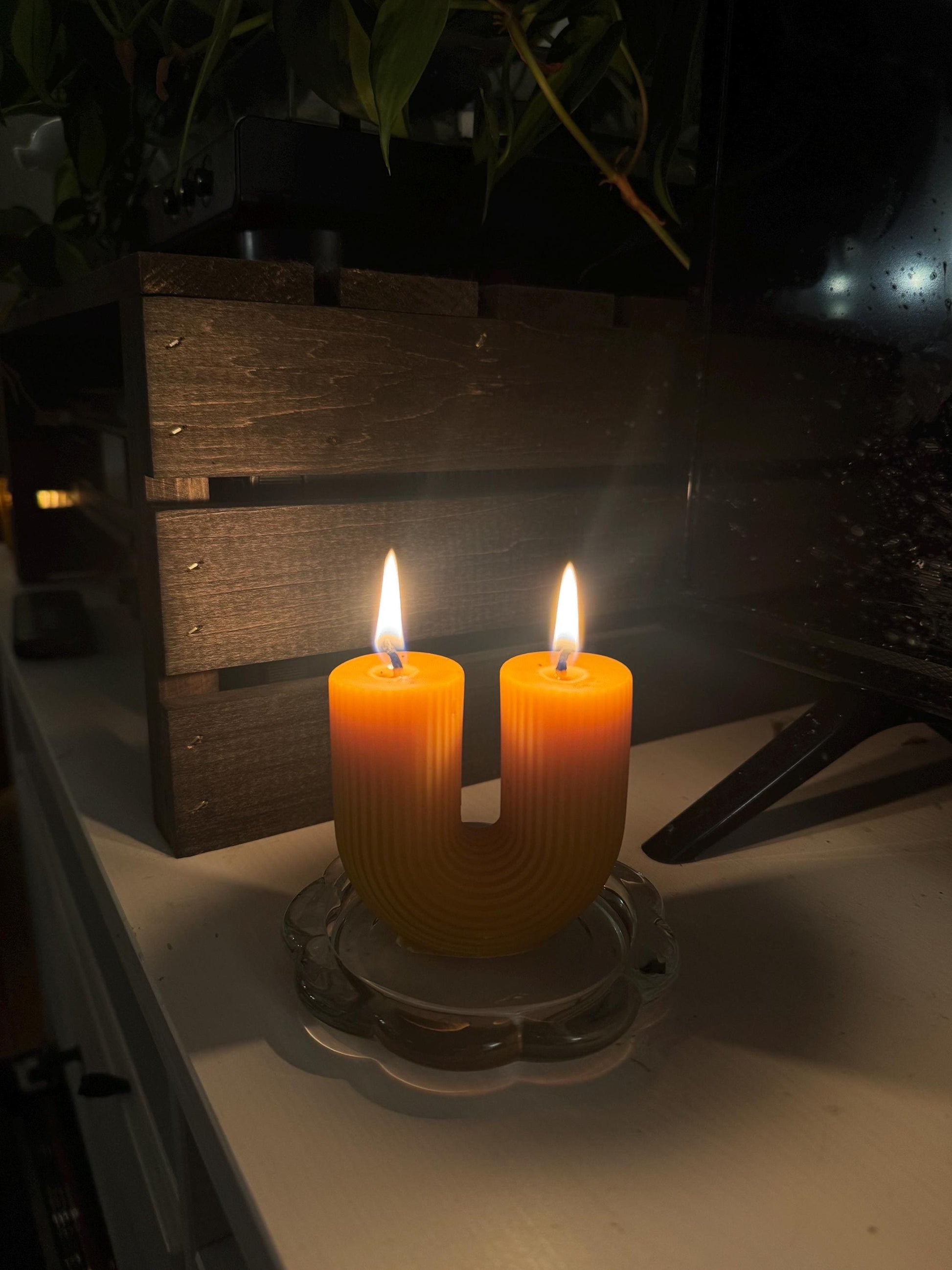 Lit beeswax candle with cotton wick