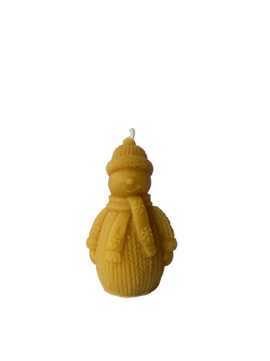 Beeswax candle shaped like a snowman wearing a hat and scarf on a white background